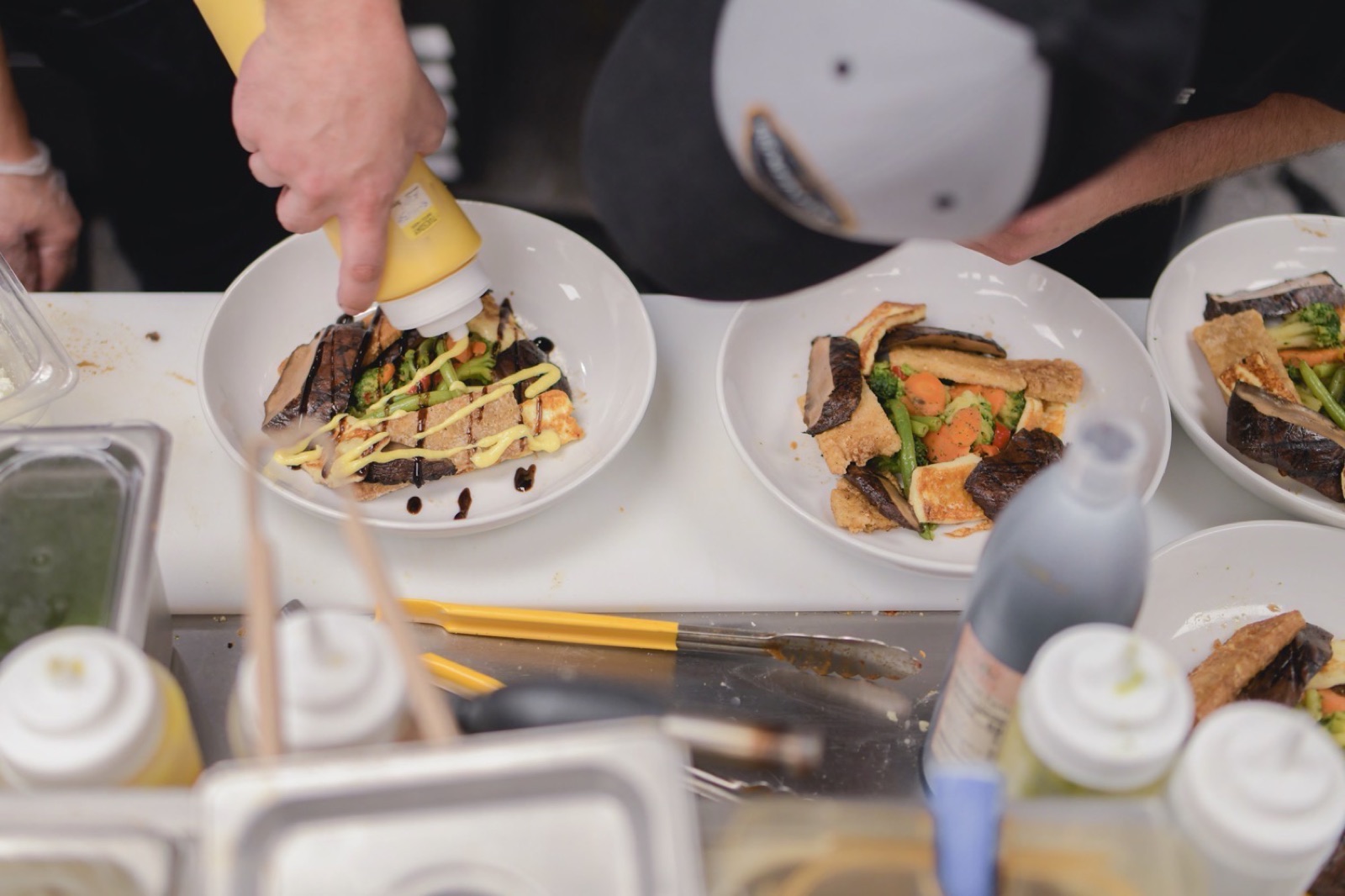 The Syndicate chefs plating catered entrées
