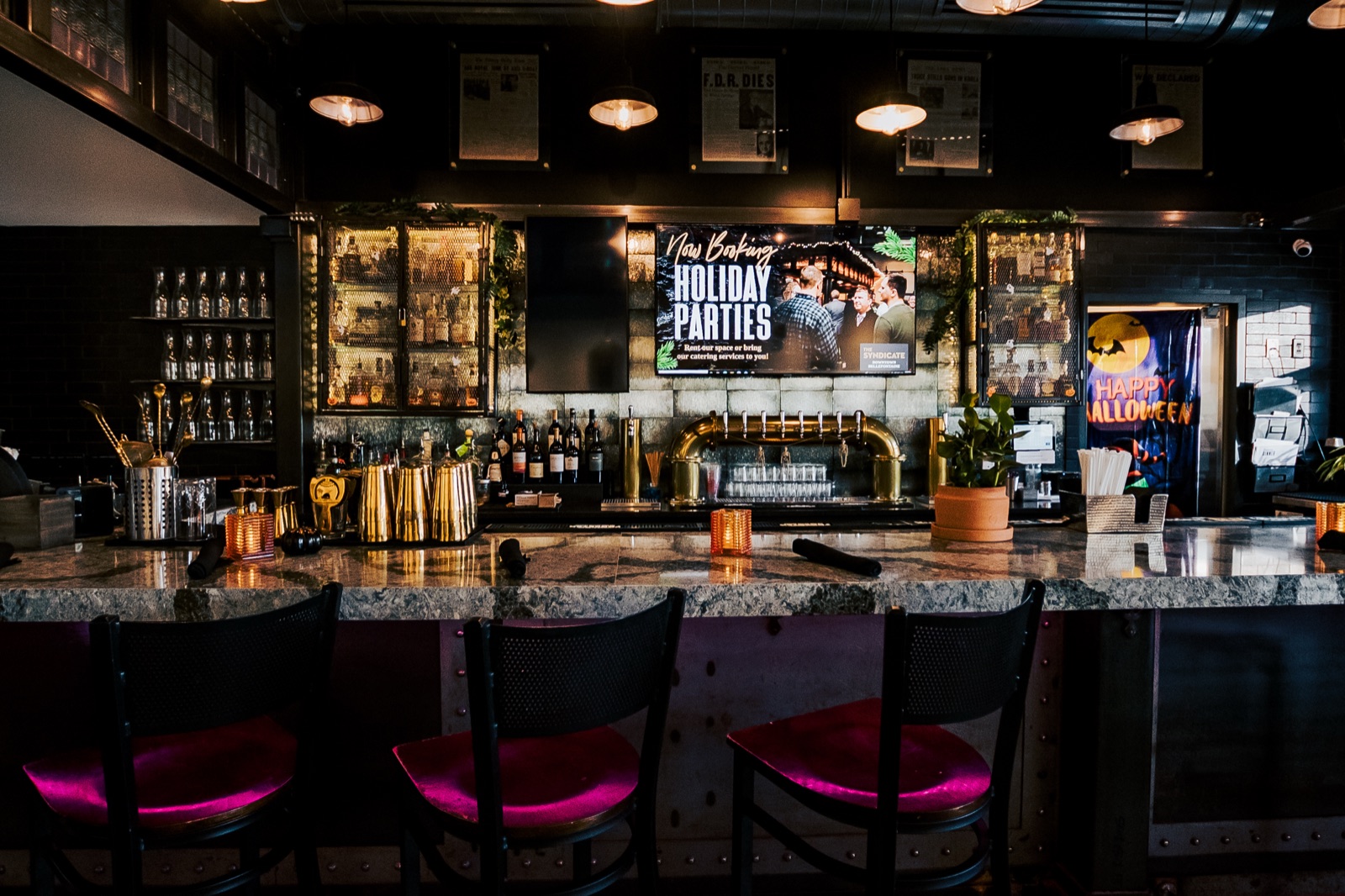 The custom-built bar at The Syndicate glowing at night