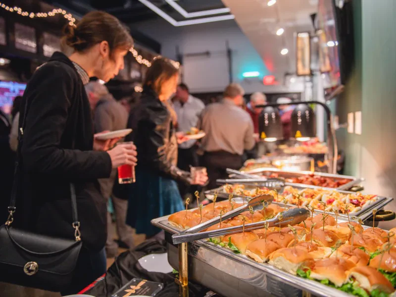 Guests serving themselves at a catered buffet line