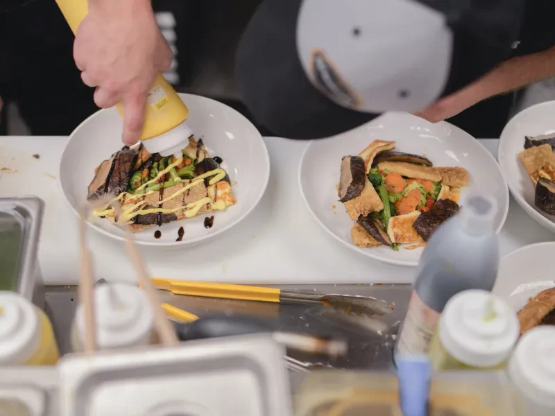 Syndicate chefs plating catered entrées